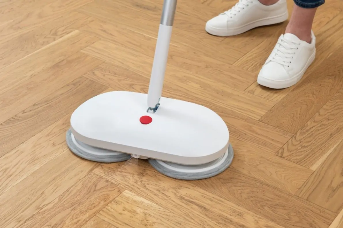 Quattro Self Cleaning Power Cordless Mop in use on timber floor